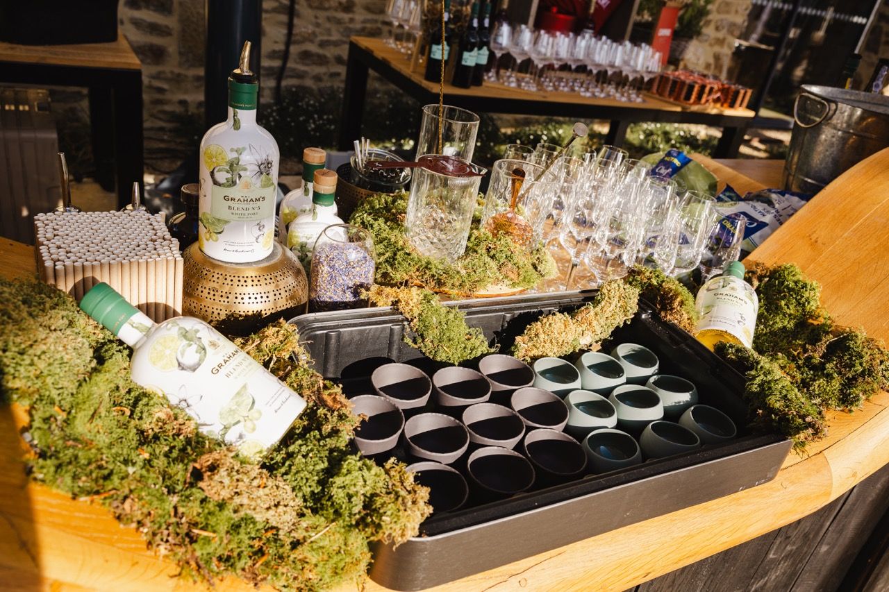 Bar counter set up with bottles and glasses for a mixology workshop