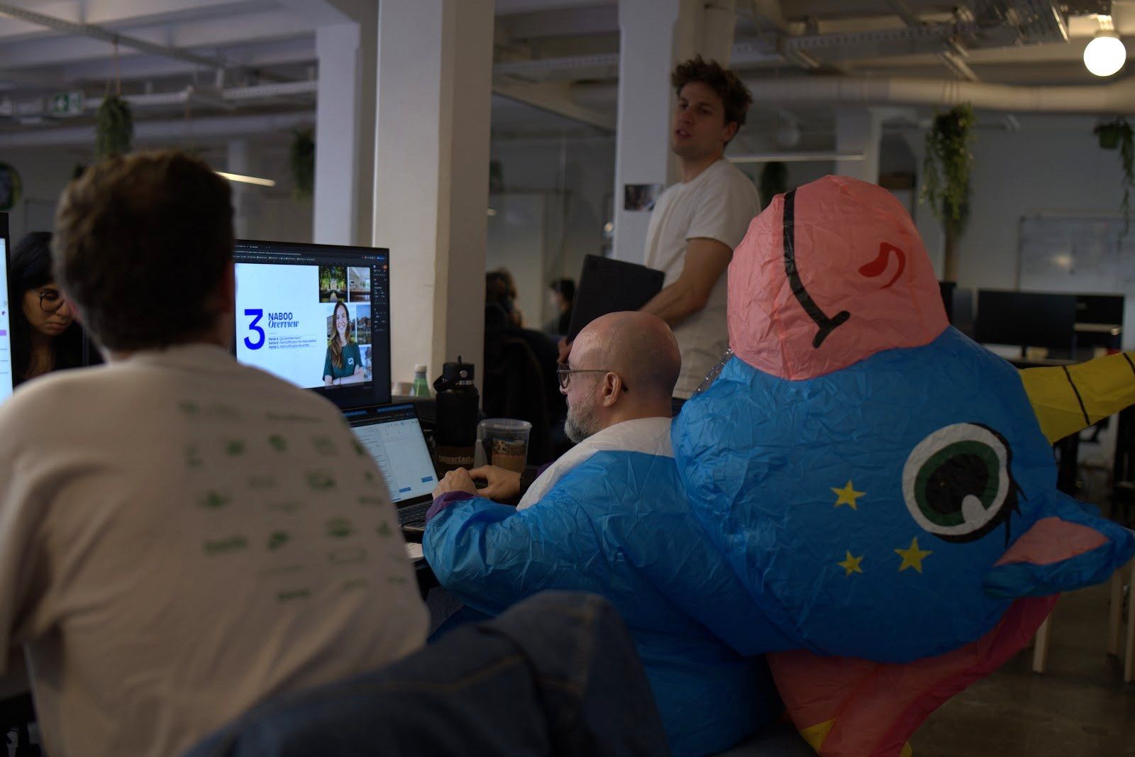 Naboo team building an AI tool at a screen during the Naboo AI hackathon in the Paris office, October 2025