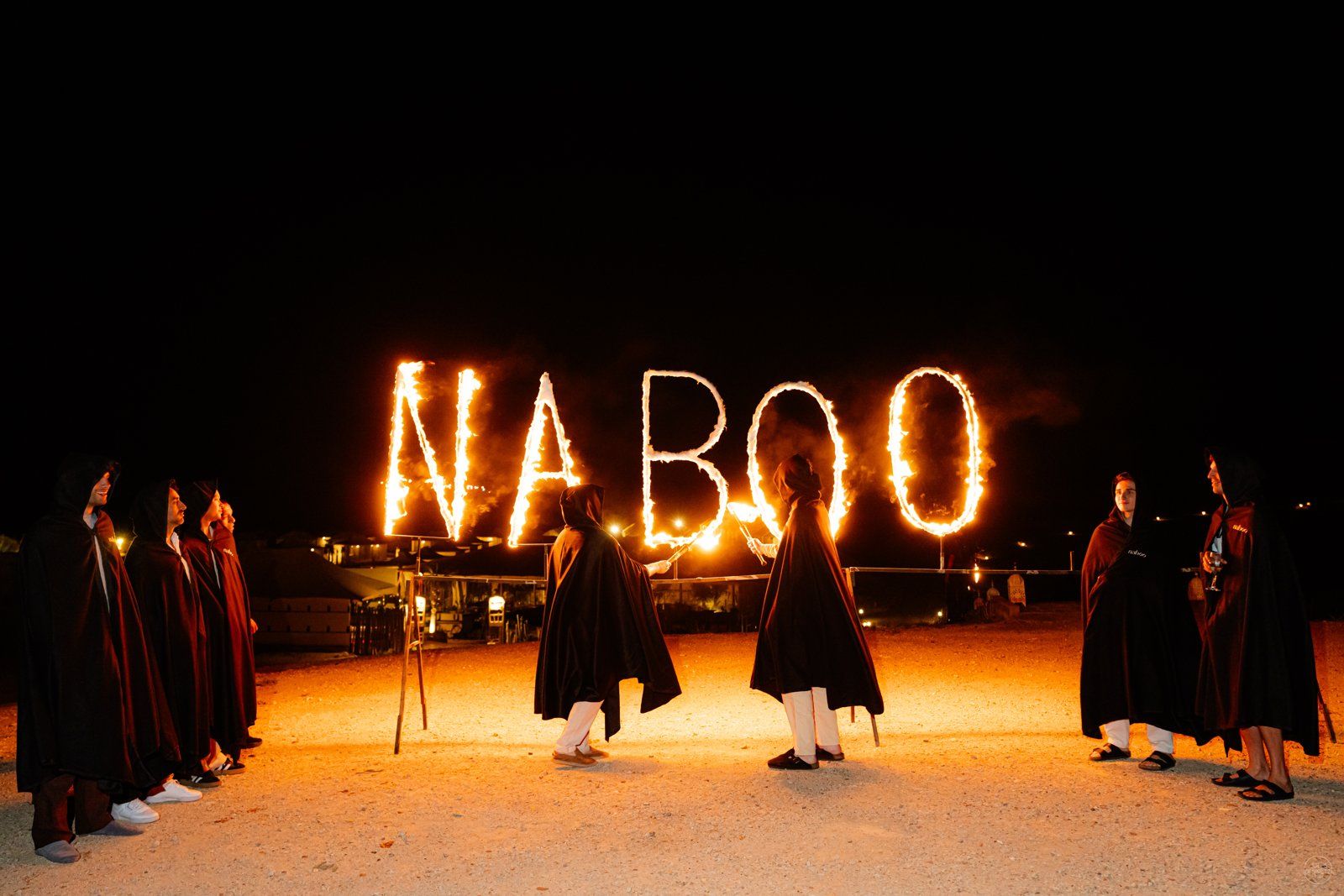 NABOO spelled out in fire during the desert night of the Naboo global offsite near Marrakech, May 2026