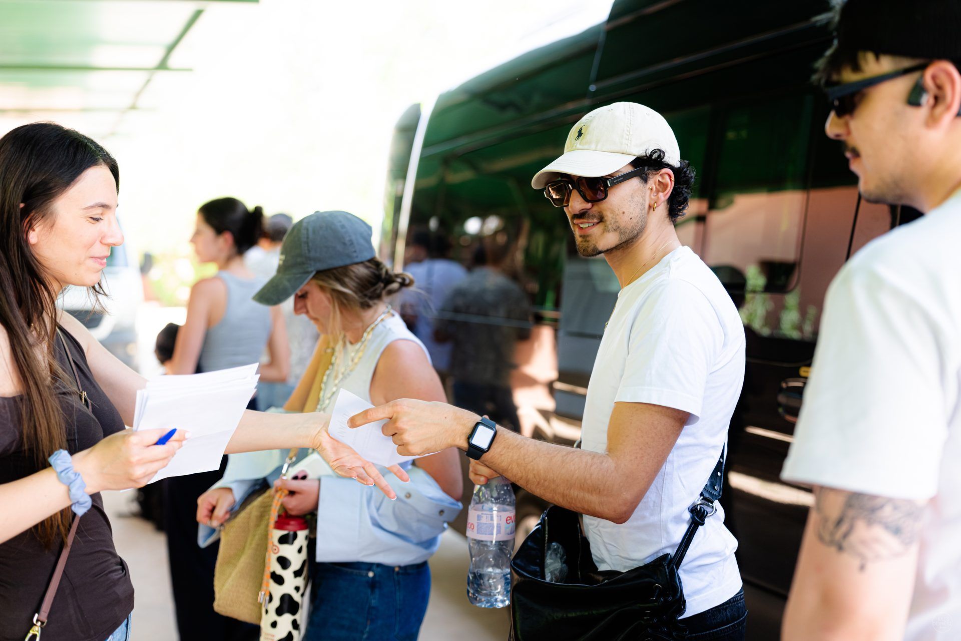 Naboo team members sharing arrival details and the program beside the coach at the start of the 2026 offsite