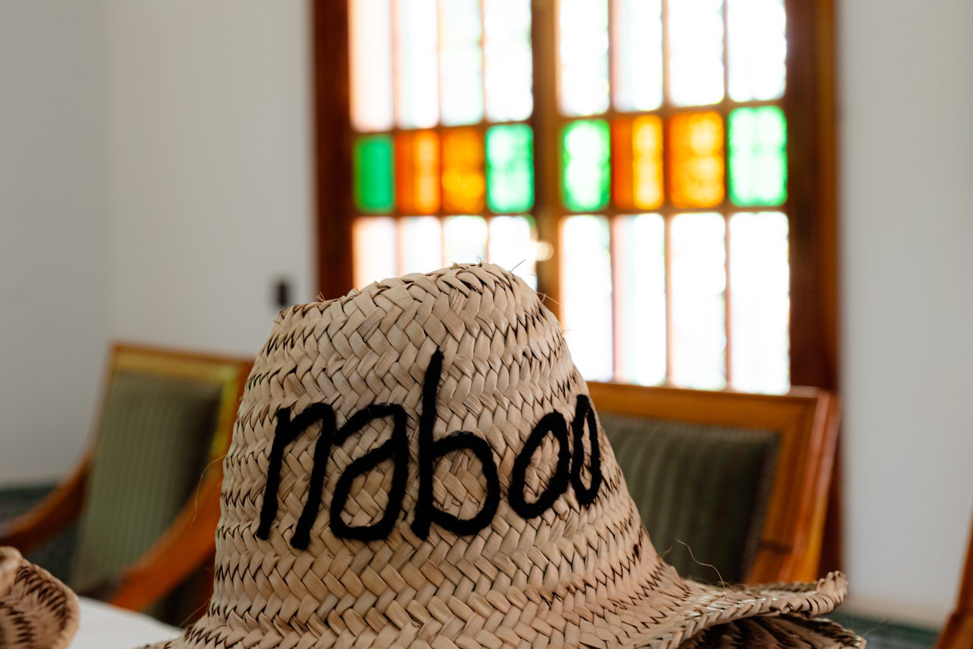 A stack of woven straw hats embroidered with naboo, ready for the team at the 2026 Marrakech offsite