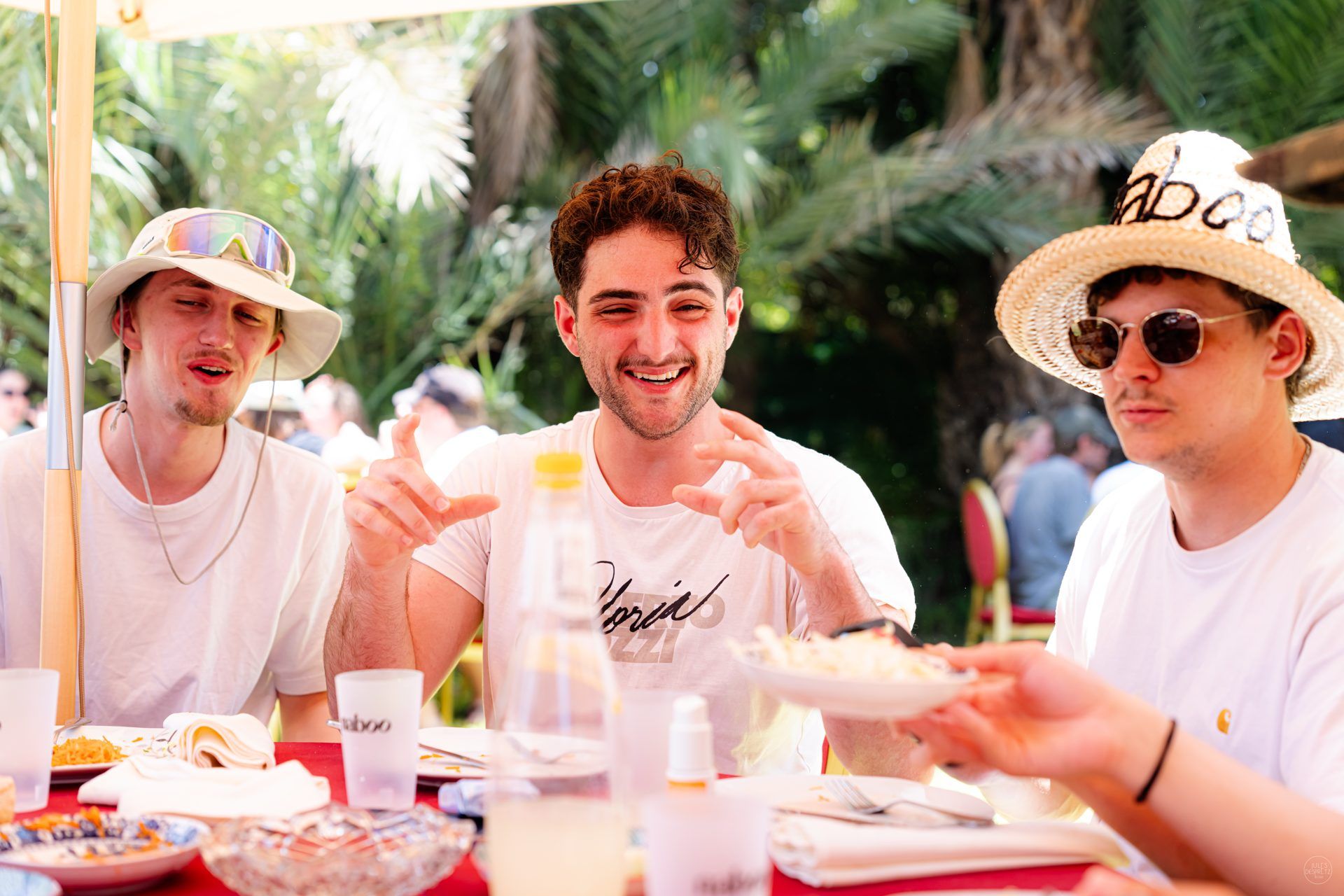 Three Naboo colleagues wearing the embroidered naboo straw hats at lunch during the 2026 Marrakech offsite