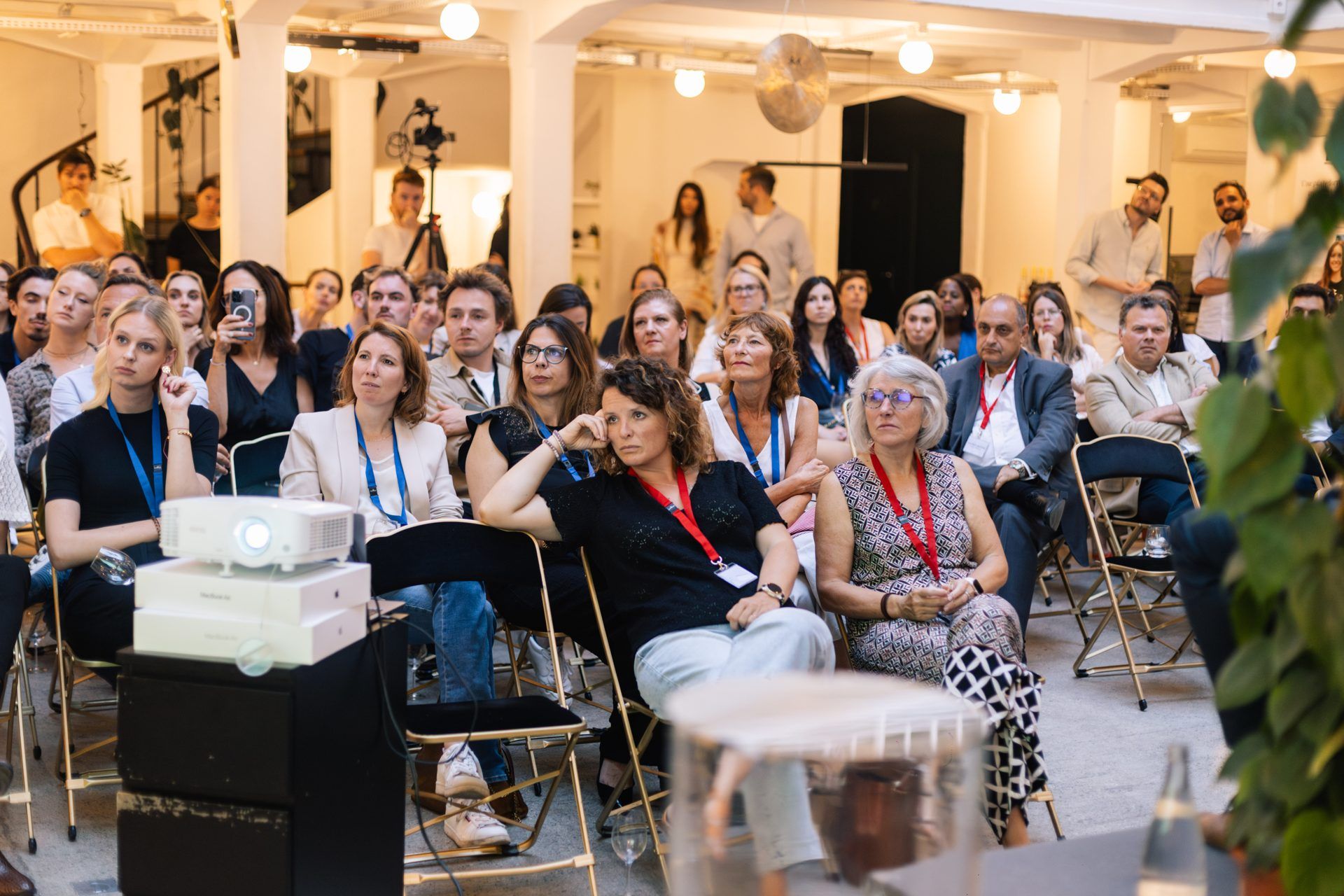 Guests seated for a talk at an evening event hosted in the Naboo office in Paris