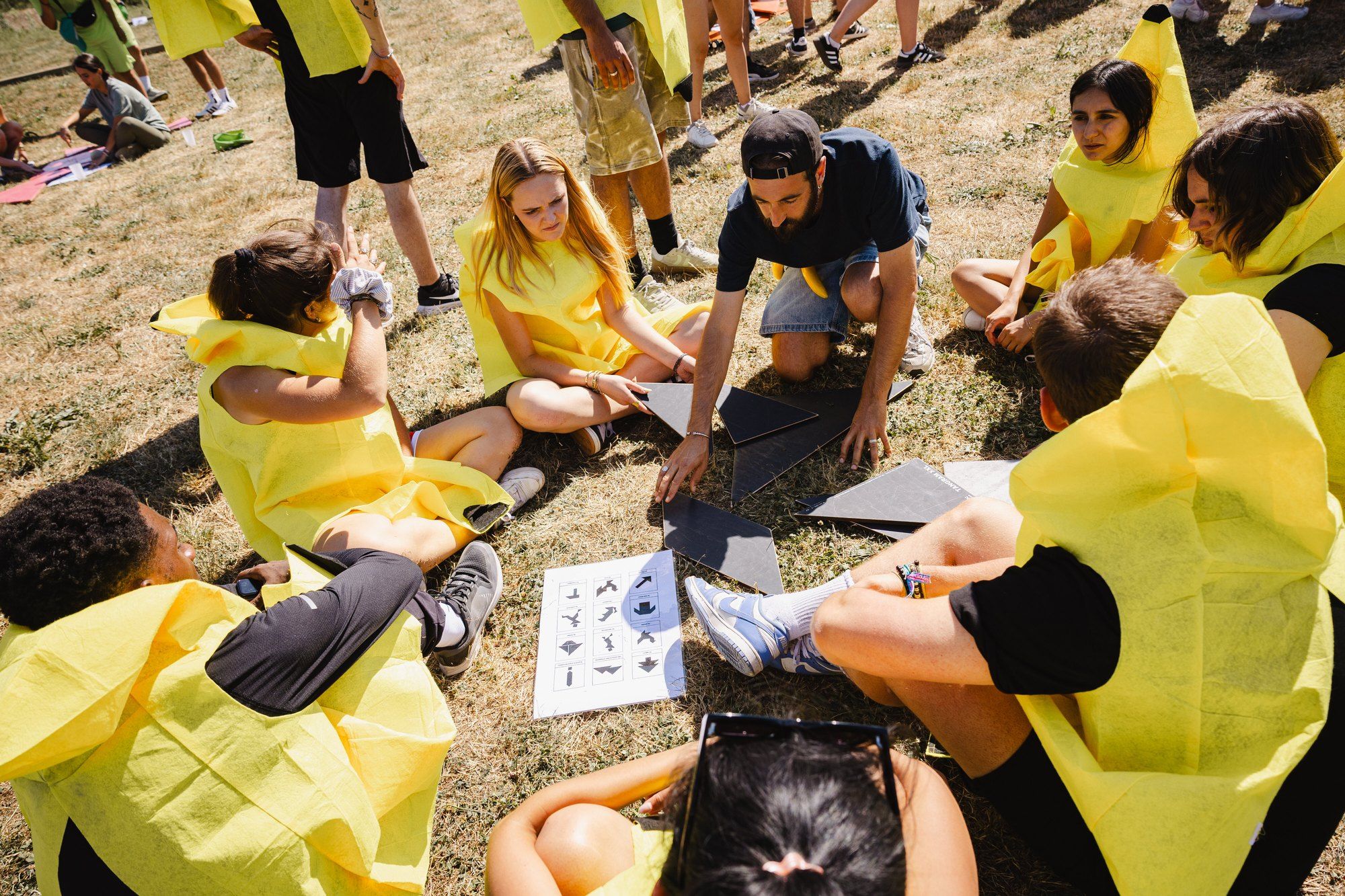 Small Naboo team sitting in a circle solving a puzzle together during a team session at the Naboo seminar, July 2025
